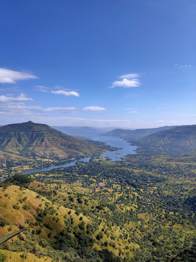 A green plateau falling away to a river valley in the western Sahyadris