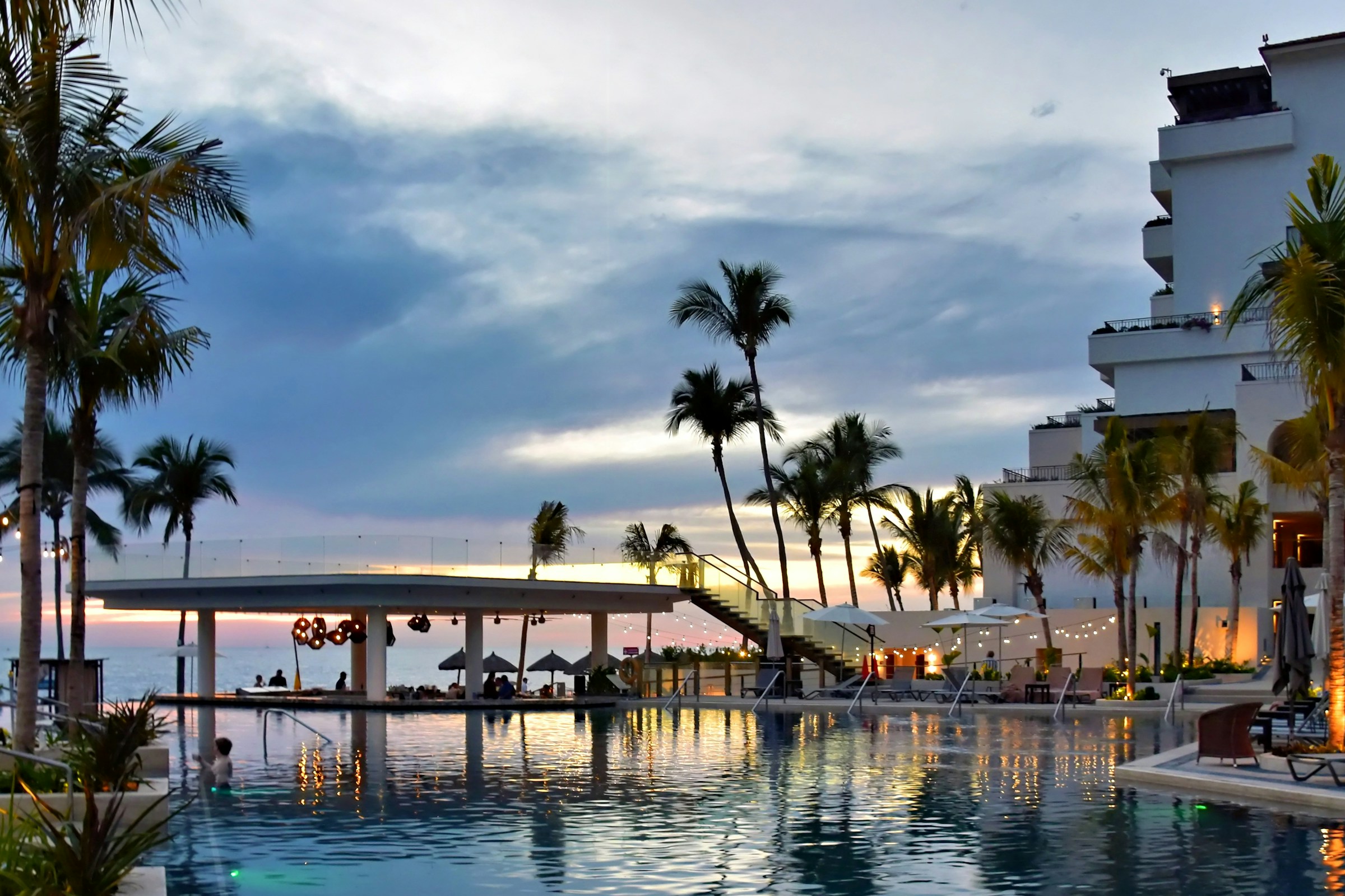 An infinity pool overlooking a sunset at a boutique stay